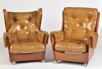 Lot 38 - A pair of teak and button leather armchairs, c....