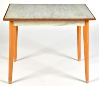 Lot 51 - A formica top teak table, raised on tapering...