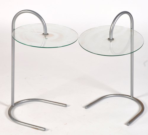 Lot 63 - A pair of glass and bent metal bedside tables,...