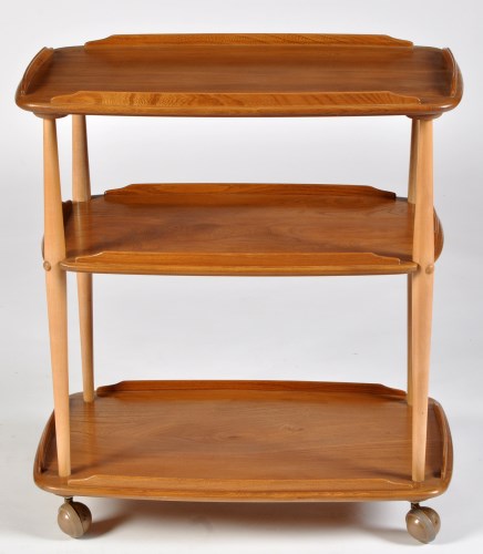 Lot 65 - Ercol: a light stained elm three-tier trolley,...