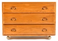 Lot 69 - An Ercol light elm chest of three long drawers,...