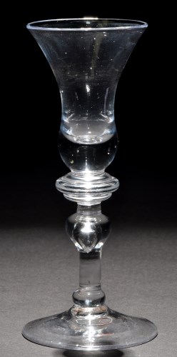 Lot 238 - A baluster wine glass, the waisted bell bowl...