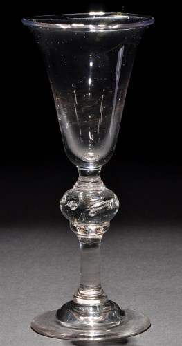 Lot 246 - A baluster wine glass, the bell bowl raised on...