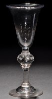 Lot 246 - A baluster wine glass, the bell bowl raised on...