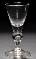 Lot 247 - A baluster wine glass, the conical bowl with a...
