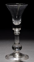 Lot 249 - A baluster wine glass, the waisted bowl with...