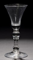 Lot 250 - A baluster wine glass, the waisted bowl with a...