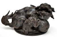 Lot 450 - Chinese bronze figure of a Buddhist lion and...