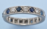 Lot 598 - A sapphire and diamond eternity ring,...