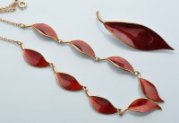 Lot 603 - A silver gilt and red enamel leaf pattern...