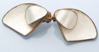 Lot 604 - A pair of white enamel silver ear clips, by...