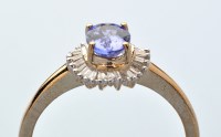 Lot 606 - A tanzanite and diamond cluster ring, the oval...