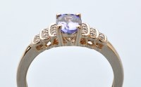 Lot 607 - A tanzanite and diamond ring, the oval facet...