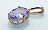 Lot 608 - A tanzanite pendant, the oval facet cut...