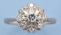 Lot 611 - A diamond cluster ring, the central brilliant...