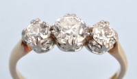 Lot 613 - A three stone diamond ring, the graduated...