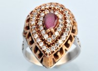 Lot 624 - A ruby and diamond cluster ring, the...