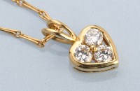 Lot 627 - A diamond heart shaped pendant, the three...