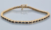 Lot 629 - A sapphire and diamond line bracelet,...