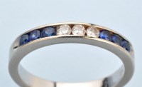 Lot 630 - A sapphire and diamond half hoop eternity ring,...