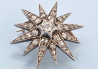 Lot 640 - A Victorian diamond star pattern brooch, the...