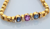 Lot 649 - A ruby, sapphire, diamond and yellow metal...