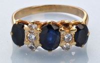 Lot 651 - A sapphire and diamond ring, three graduated...