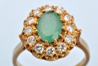 Lot 655 - An emerald and diamond cluster ring, the...