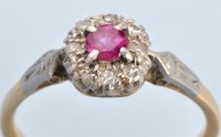 Lot 660 - A ruby and diamond cluster ring, the circular...