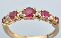 Lot 661 - A ruby and diamond ring, the graduated...