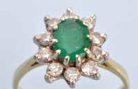 Lot 662 - An emerald and diamond cluster ring, the oval...