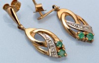 Lot 665 - A pair of emerald, diamond and 9ct. yellow...