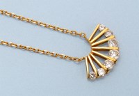 Lot 667 - A diamond and yellow metal fan pattern pendant,...