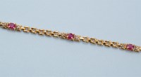 Lot 668 - A ruby, diamond and yellow metal bracelet, set...