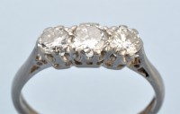 Lot 674 - A three stone diamond ring, the graduated...