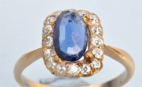 Lot 675 - A sapphire and diamond cluster ring, the oval...