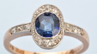 Lot 680 - A sapphire and diamond cluster ring, the...