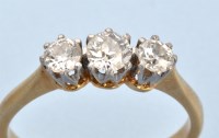 Lot 687 - A three stone diamond ring, the graduated...