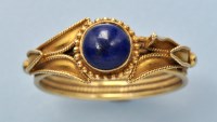 Lot 700 - A lapis lazuli and 18ct. yellow gold ring, the...