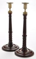 Lot 810 - A pair of George III mahogany candlesticks,...