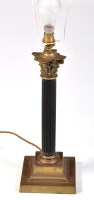 Lot 824 - An early 20th brass and ebony table lamp, the...