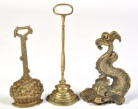 Lot 836 - Three 19th Century brass door stops, one in...