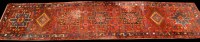 Lot 887 - A Heriz runner, the red ground decorated with...