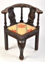 Lot 942 - A Victorian carved and ebonised oak corner...