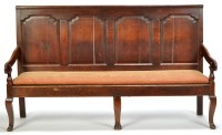 Lot 947 - An 18th Century oak settle, the panel back...