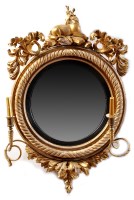 Lot 1004 - *A Regency giltwood girandole wall mirror, the...