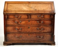 Lot 1043 - *A George III mahogany bureau, the fall-flap...