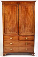 Lot 1093 - A George III mahogany linen press, the flared...