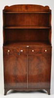 Lot 1102 - A George III style waterfall bookcase, the...