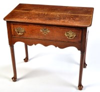 Lot 1111 - *An 18th Century oak lowboy, the frieze drawer...